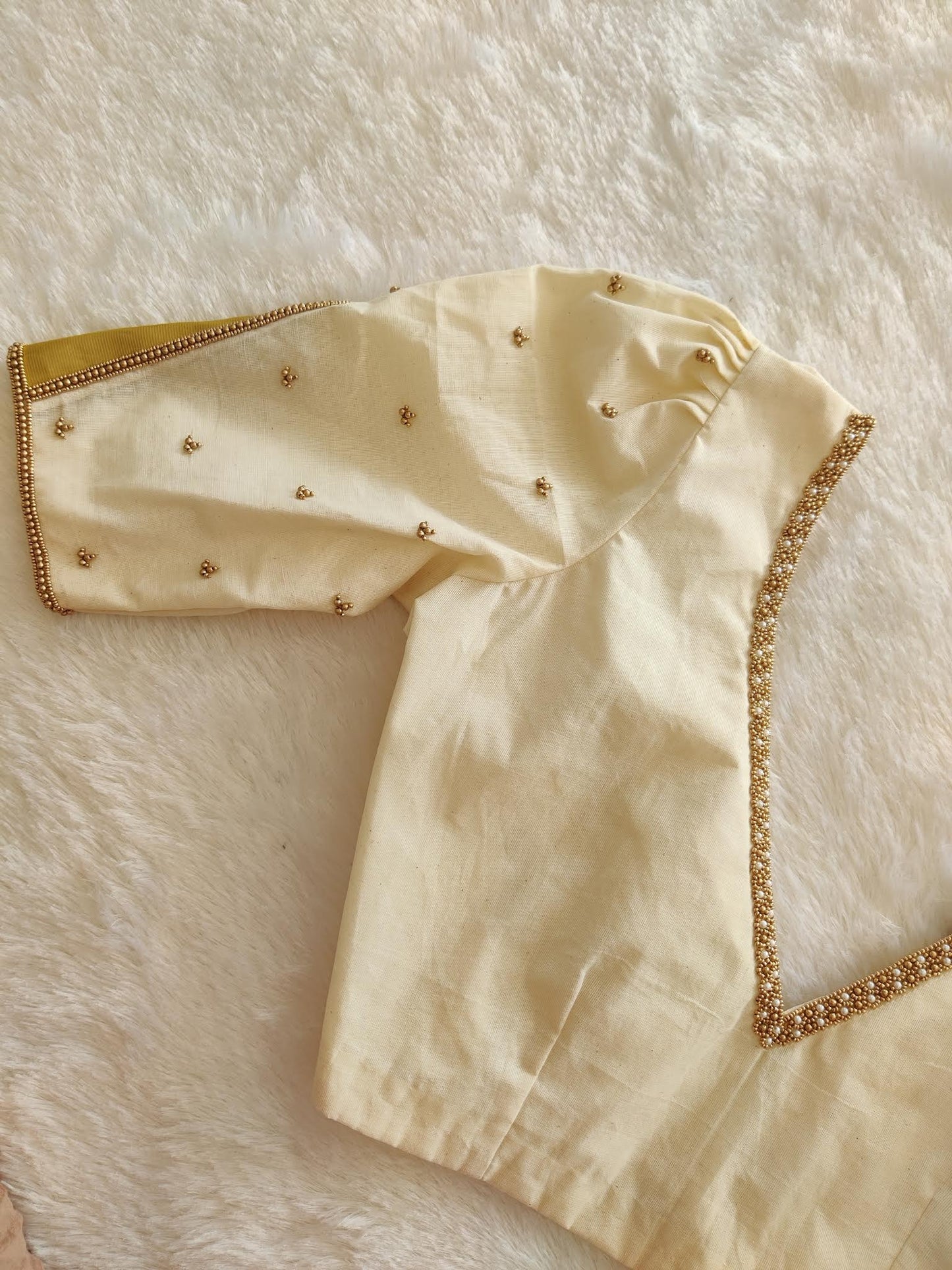 Off-white handworked blouse